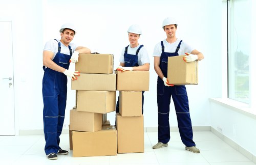 Removal team loading household items into a van
