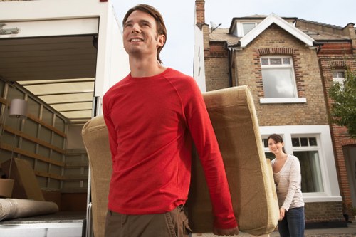 Packed moving boxes and furniture ready for transport in Sutton