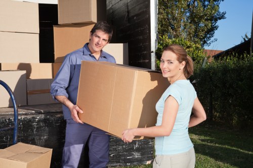 Professional movers handling furniture and boxes during a Sutton relocation